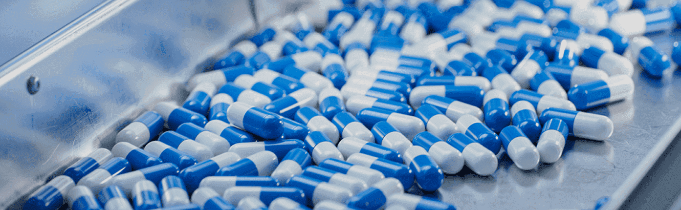 Conveyor belt with blue pill capsules